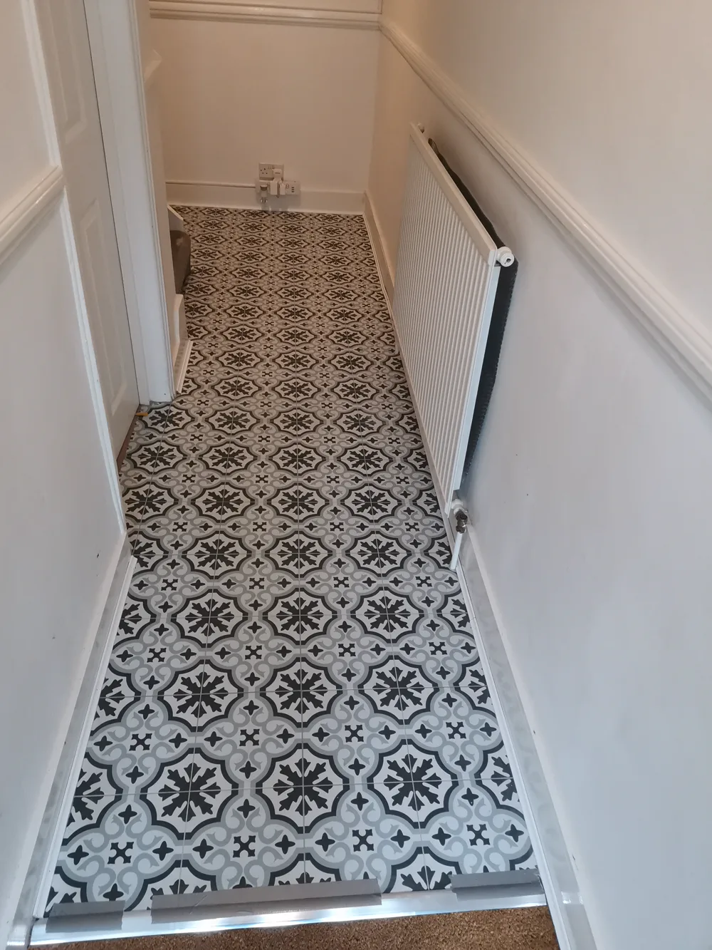Real Vision Builder job: patterned geometric floor tile laid in a hallway